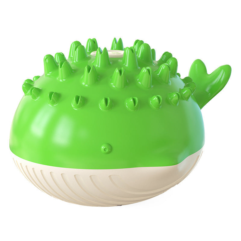 Green and white electric floating spray dog toy shaped like a pufferfish with spikes and a tail fin for summer water play